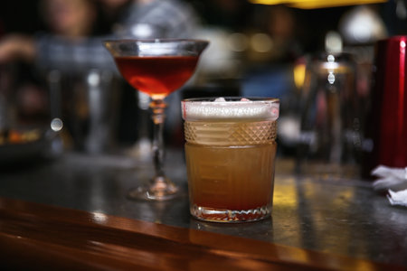 Glasses of tasty cocktails on bar counter