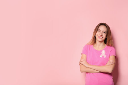 Woman with silk ribbon and space for text on color background. breast cancer awareness conceptの写真素材