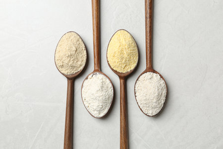 Spoons with different types of flour on table, top viewの写真素材