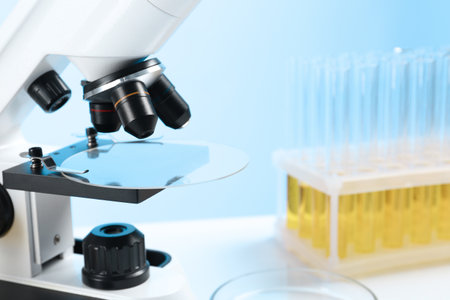 Microscope with glass slide on table in laboratory, space for text. medical analysis