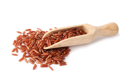 Scoop and uncooked brown rice on white backgroundの写真素材