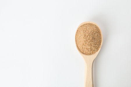 Spoon of buckwheat flour isolated on white, top view with space for textの写真素材