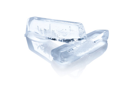 Pieces of ice melting on white backgroundの写真素材
