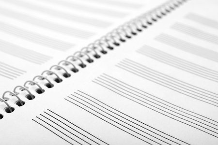 Notebook with empty staves for music notes as background, closeupの写真素材