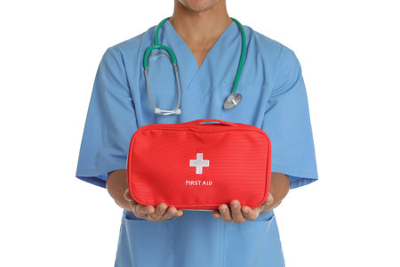 Male doctor holding first aid kit on white background, closeup. medical objectの写真素材