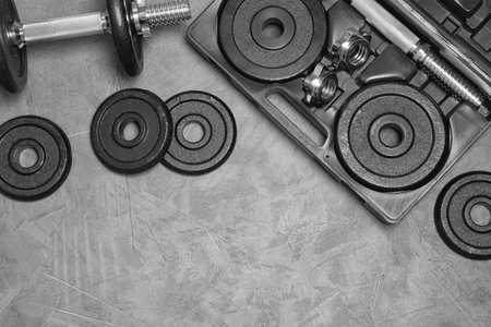 Flat lay composition with dumbbell and space for text on gray backgroundの写真素材