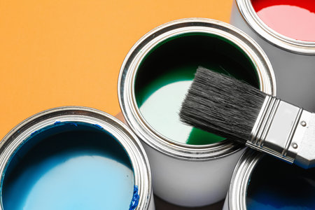 Close up view of paint cans and brush on color backgroundの写真素材