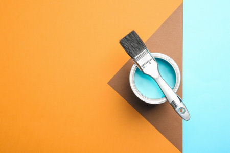 Paint can and brush on color background, top view. Space for textの写真素材
