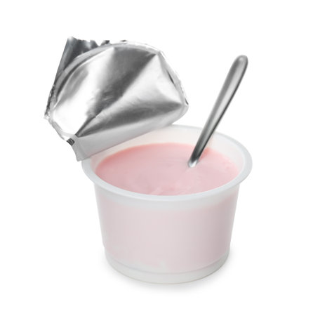 Plastic cup with creamy yogurt and spoon on white backgroundの写真素材