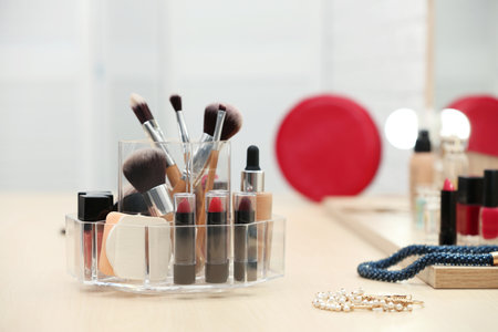Organizer with cosmetic products and makeup accessories on dressing tableの写真素材