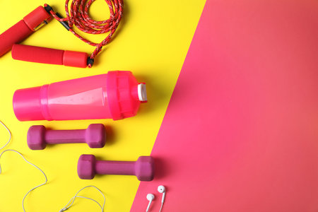 Flat lay composition with fitness gym equipment on color background. Space for textの写真素材