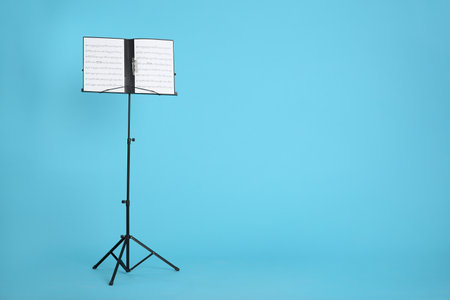 Note stand with music sheets on color background. Space for textの写真素材