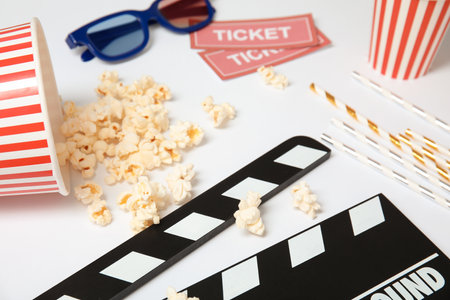 Clapper, popcorn and tickets on white background. cinema snackの写真素材