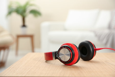Stylish headphones on table indoors. Space for text