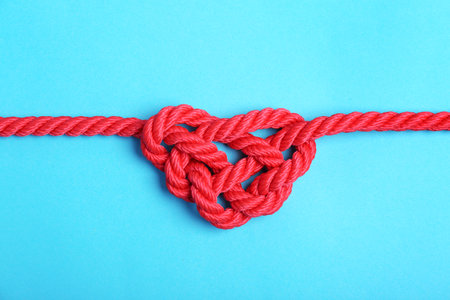 Heart made of red rope on color background, top viewの写真素材