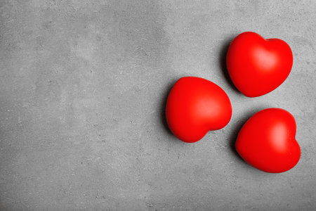 Red decorative hearts on gray background, top view with space for textの写真素材