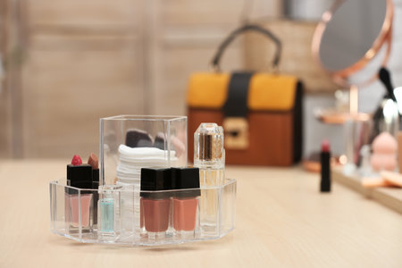 Organizer with cosmetic products and makeup accessories on dressing table. Space for textの写真素材