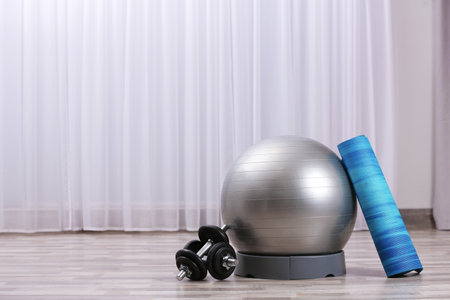 Set of fitness equipment on floor indoors. Space for textの写真素材