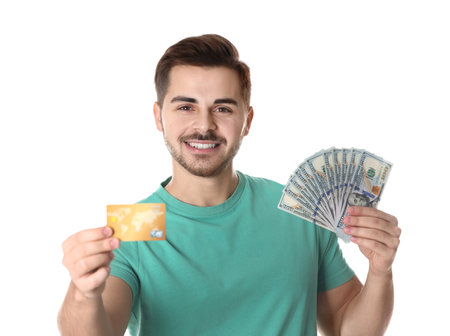 Portrait of happy young man with money and credit card on white backgroundの写真素材