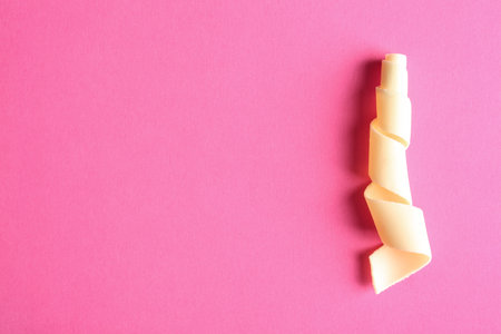 Yummy white chocolate curl and space for text on color background, top viewの写真素材