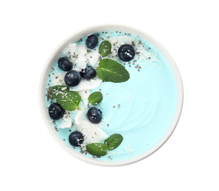 Bowl of spirulina smoothie with coconut, blueberries and chia seeds isolated on white, top viewの写真素材