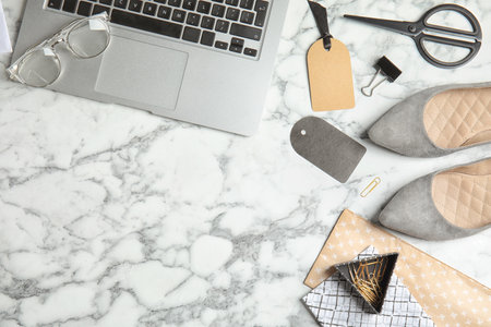 Flat lay composition with stylish shoes, laptop and space for text on marble background. fashion...