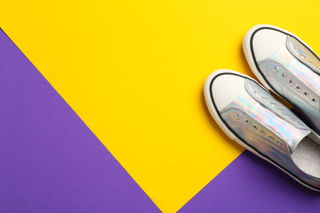 Pair of stylish sneakers on color background, top view with space for textの写真素材