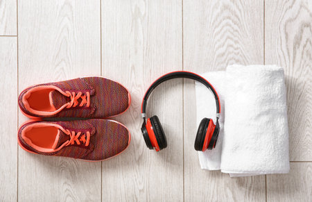 Flat lay composition with sneakers, headphones and towels on wooden backgroundの写真素材