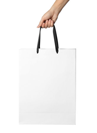 Woman holding paper shopping bag isolated on white, closeupの写真素材