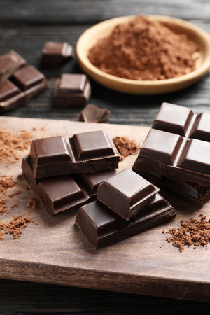 Pieces of black chocolate on wooden boardの写真素材