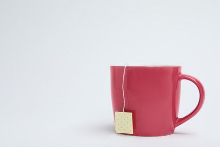 Cup of tasty tea on white background