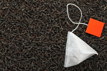 Tea bag on dry leaves, top view with space for textの写真素材