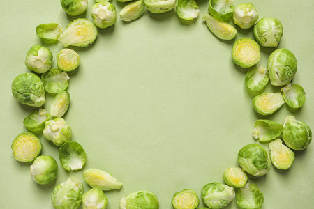 Frame made with Brussels sprouts on color background, top view. Space for textの写真素材