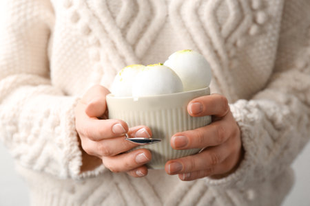 Woman with bowl of snow ice cream, closeupの写真素材