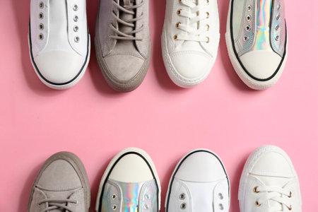 Flat lay composition with stylish sneakers on color background, space for textの写真素材