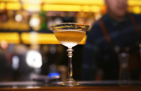Glass of tasty cocktail on bar counterの写真素材