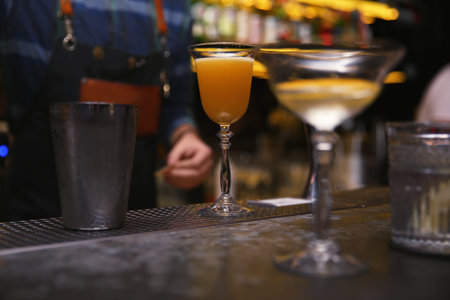 Glass of tasty cocktail on bar counterの写真素材