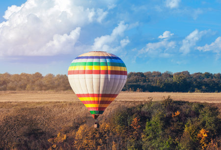 Beautiful view of hot air balloon flying over countrysideの写真素材