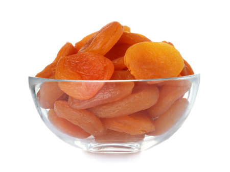 Bowl with apricots on white background. Dried fruit as healthy foodの写真素材