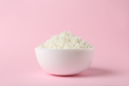 Bowl of boiled rice on color backgroundの写真素材