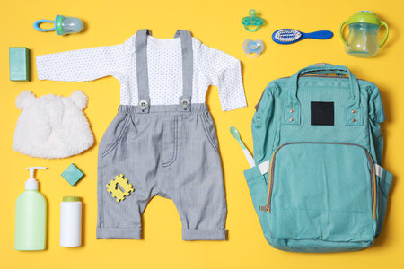 Flat lay composition with baby accessories and maternity backpack on color backgroundの写真素材
