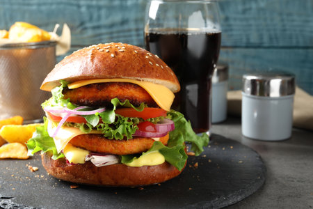 Slate plate with double vegetarian burger on tableの写真素材