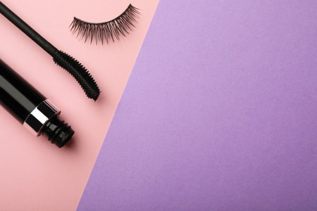 Mascara and artificial eyelashes on color background, flat lay with space for textの写真素材