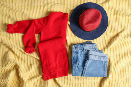 Flat lay composition with cashmere sweater, hat and jeans on soft plaidの写真素材