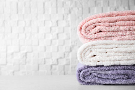 Stack of soft bath towels on table. Space for textの写真素材