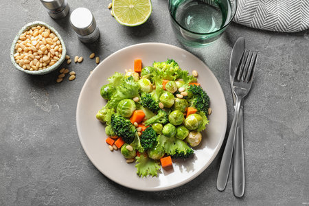 Salad with Brussels sprouts served on gray table, flat layの写真素材