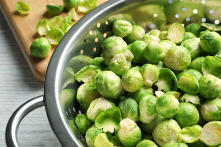 Tasty Brussels sprouts in colander on table, closeupの写真素材