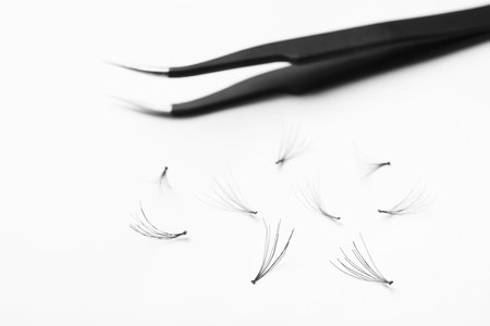 False eyelashes and tweezers on white background, closeupの写真素材