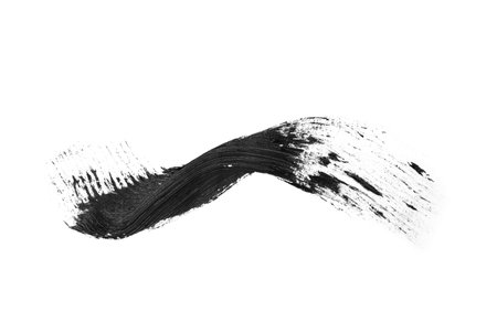 Smear of black mascara for eyelashes on white backgroundの写真素材