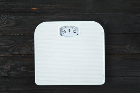 Scales on wooden background, top view. weight lossの写真素材